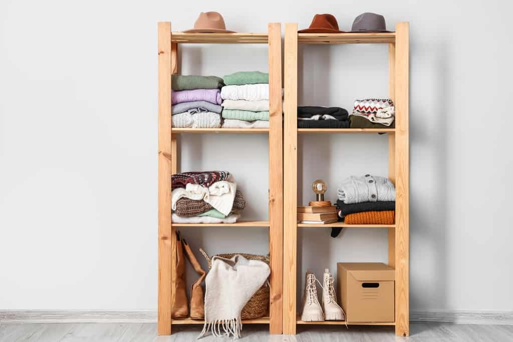 store clothes in a shelving unit without a closet