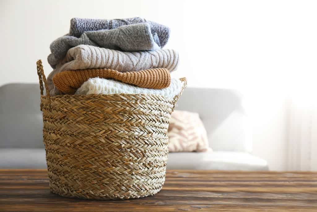 store clothes in a woven baskets without a closet