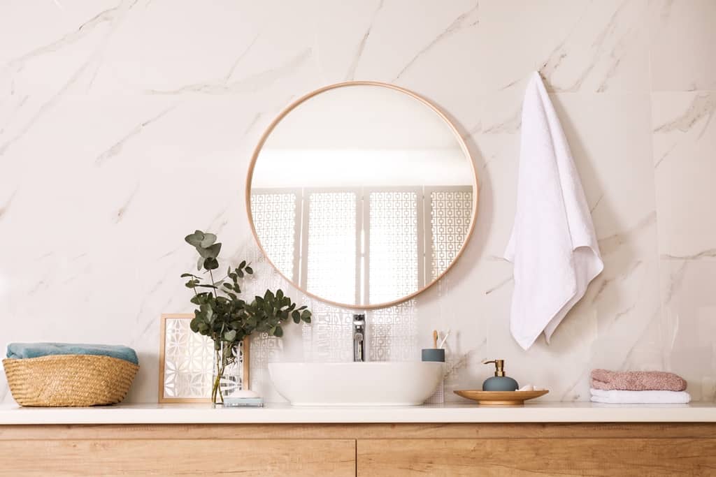 stylish bathroom with sink and round mirror