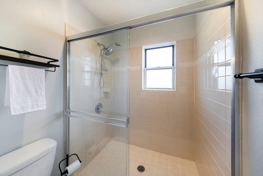 bathroom with beige square tiles