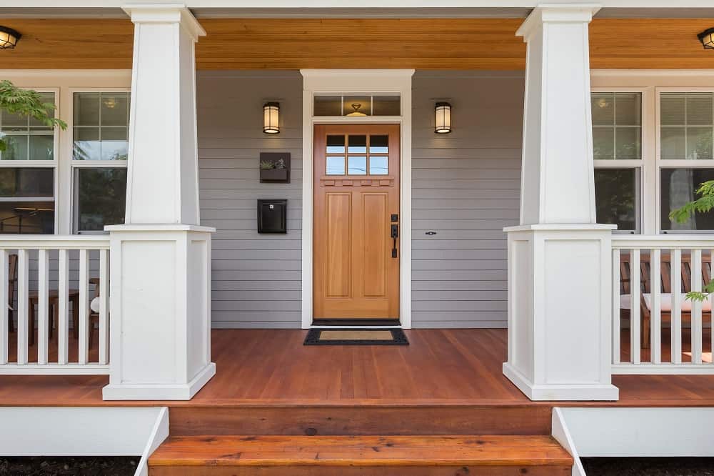 front door in a covered porch home exterior