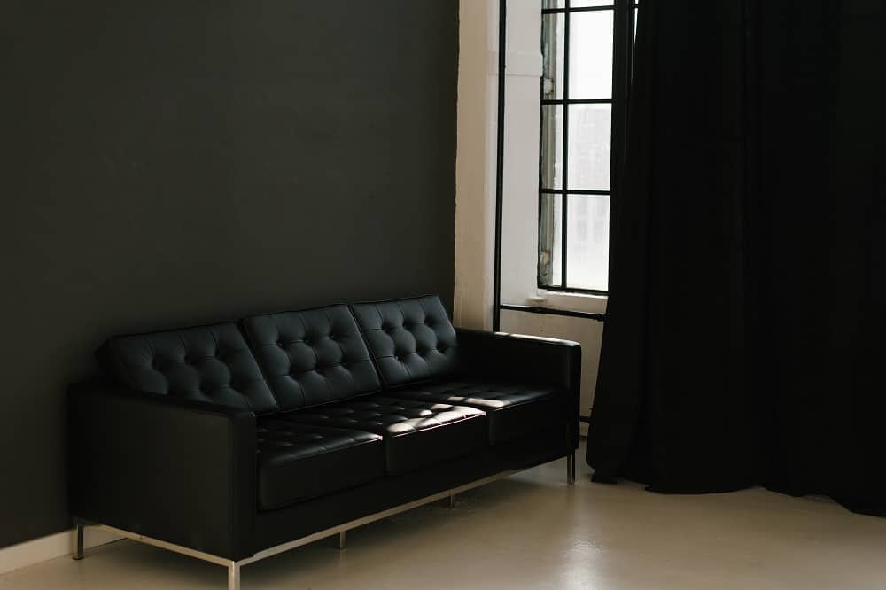 living room on grey wall with black curtains