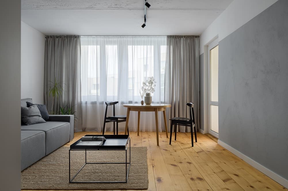 living room on grey wall with grey curtains