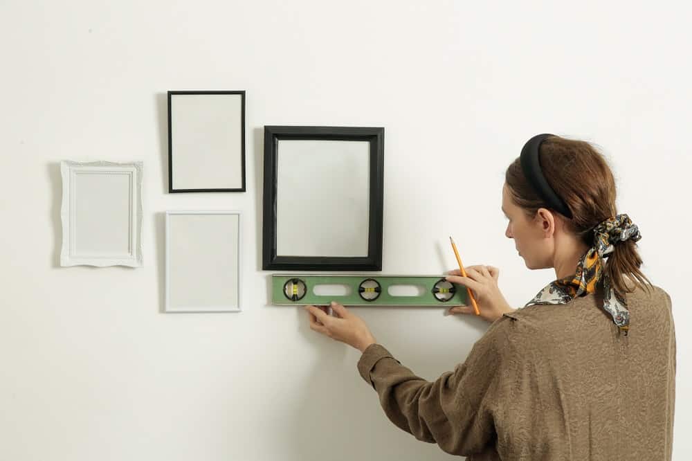 woman measuring display photo frames