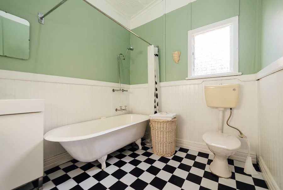 green color paint with black and white tile bathroom