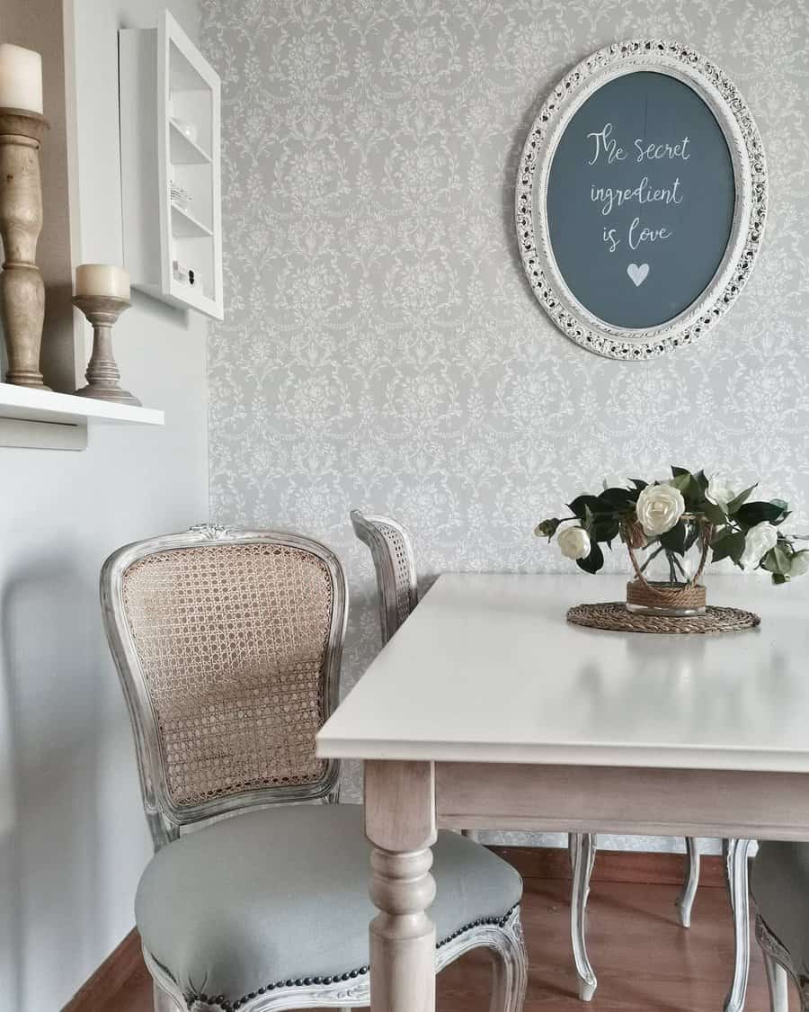 Elegant dining space with vintage-inspired chairs, a white table, a floral centerpiece, and a charming framed quote on the wall