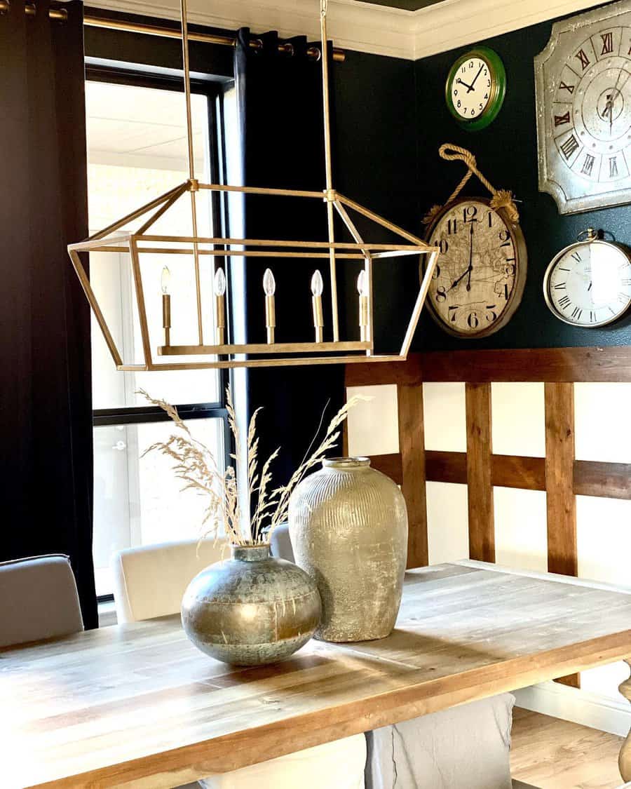 Dining room with a chandelier, two decorative vases on the table, and various wall clocks, black curtains and wooden accents add warmth