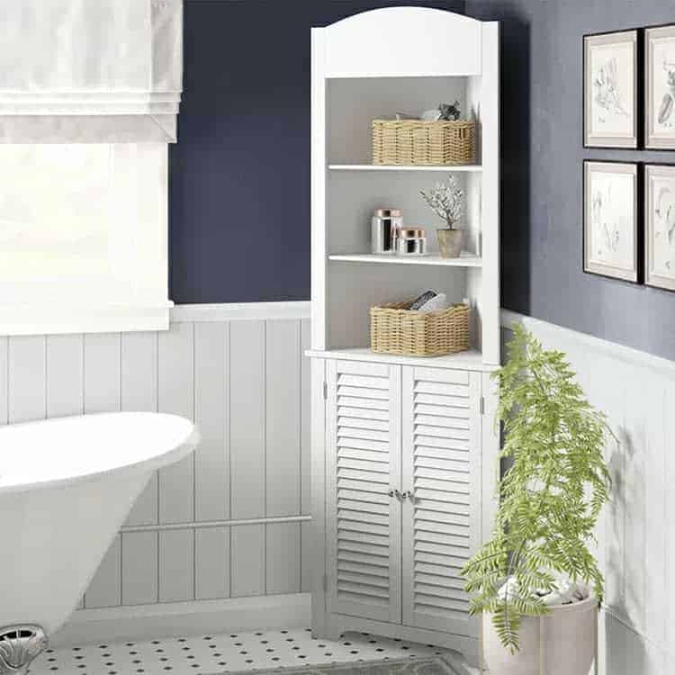 Bathroom corner cabinet with open shelves, wicker baskets, and decor items