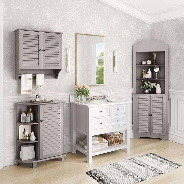 Elegant bathroom with gray louvered storage cabinets, open shelving, and a white vanity for a classic and organized space