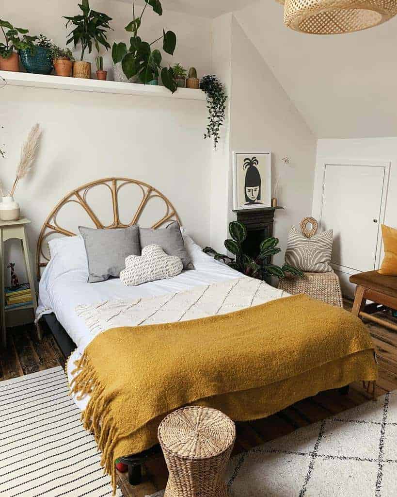 Cozy boho bedroom with a rattan headboard, floating plant shelf, warm-toned bedding, and woven storage accents for a relaxed vibe