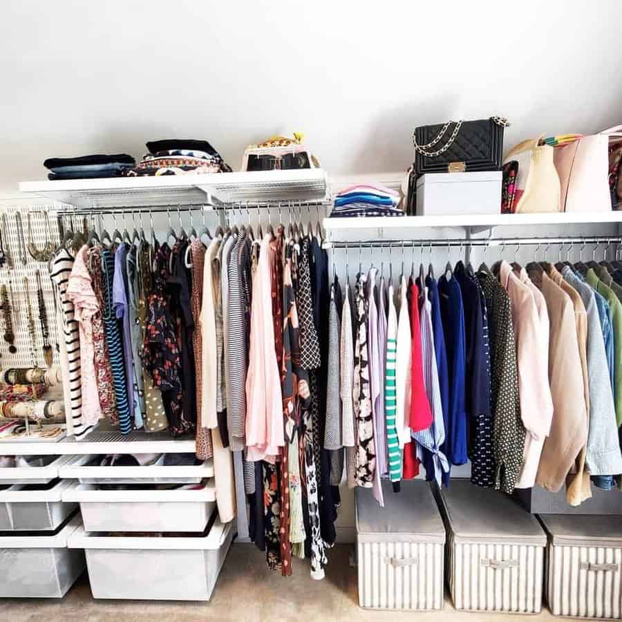 Organized closet with clothes on hangers, shelves with folded items, and storage bins below, neatly arranged accessories on the side