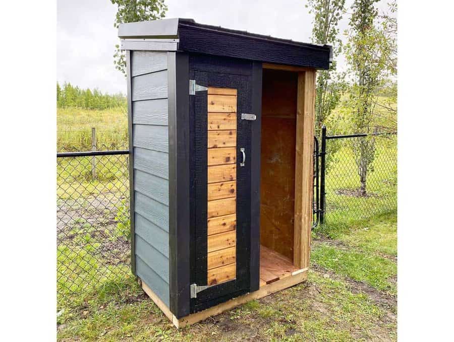 small black and wood shed
