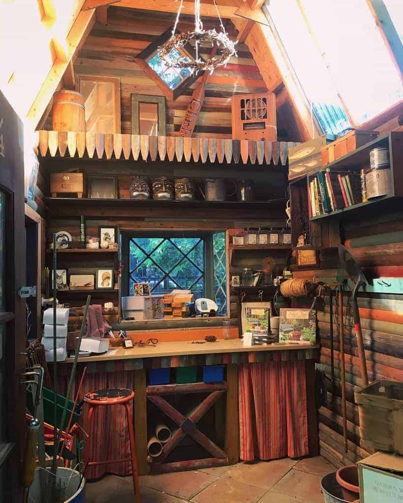 Rustic shed with wooden shelves, vintage decor, gardening tools, and overhead storage, creating a cozy and functional workspace