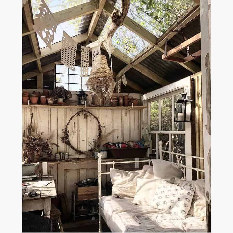 Cozy pallet shed retreat with rustic decor, a glass roof for natural light, and vintage-inspired details for a warm, inviting atmosphere