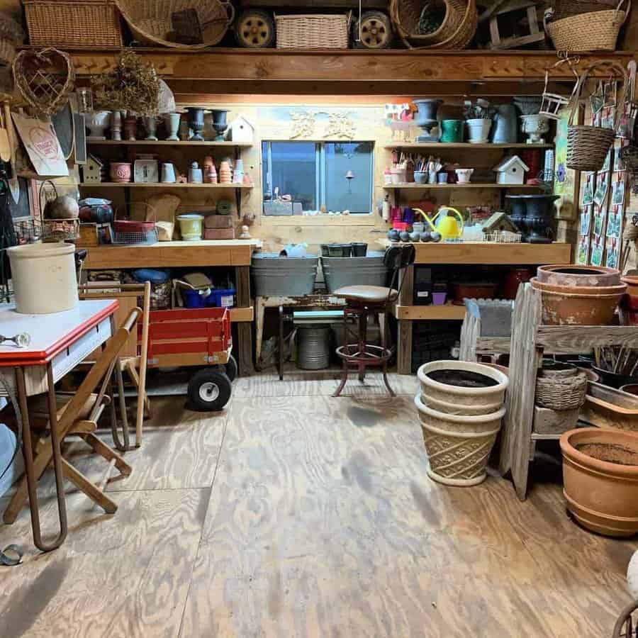 Rustic garden shed with wooden shelves, pots, baskets, and gardening tools, creating a cozy and functional workspace for planting