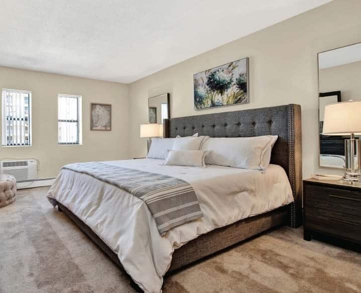 Modern bedroom with a large bed and two windows