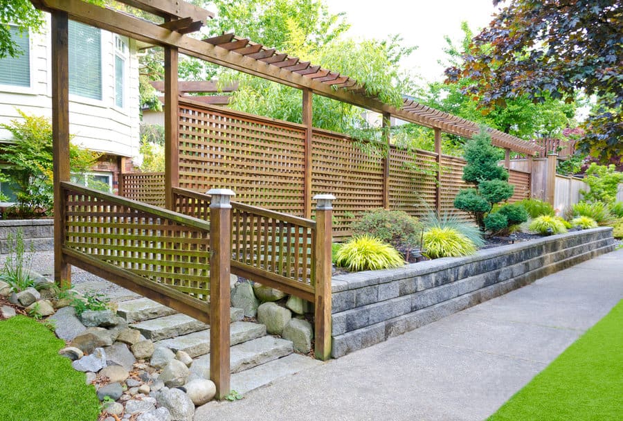 Elevated garden bed with wooden trellis and lawn