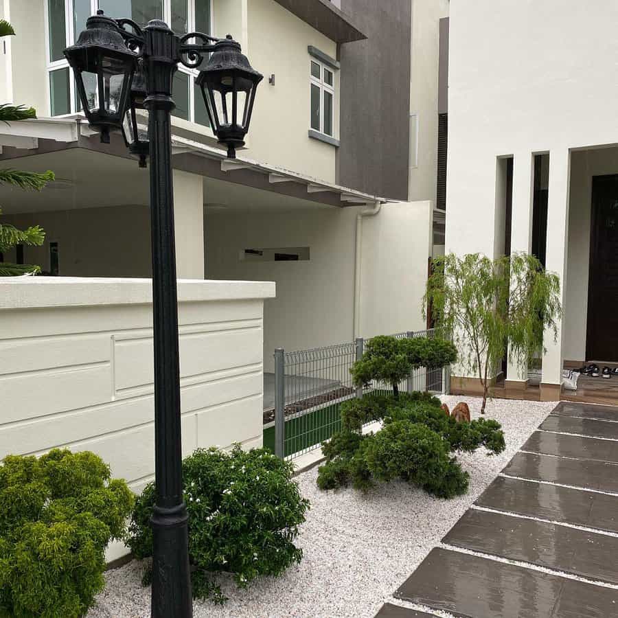 Front yard with lamp post and shrubs