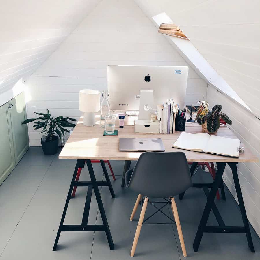 Minimalist attic workspace with iMac and plants