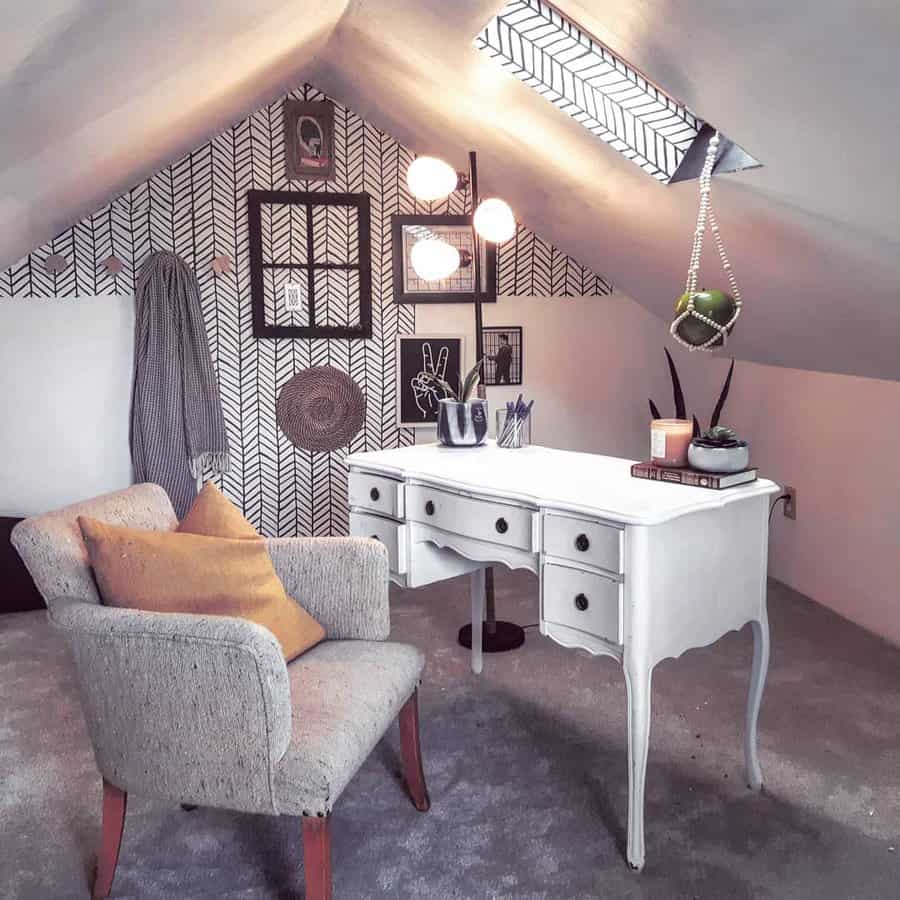 Boho chic attic office with patterned wallpaper and vintage desk