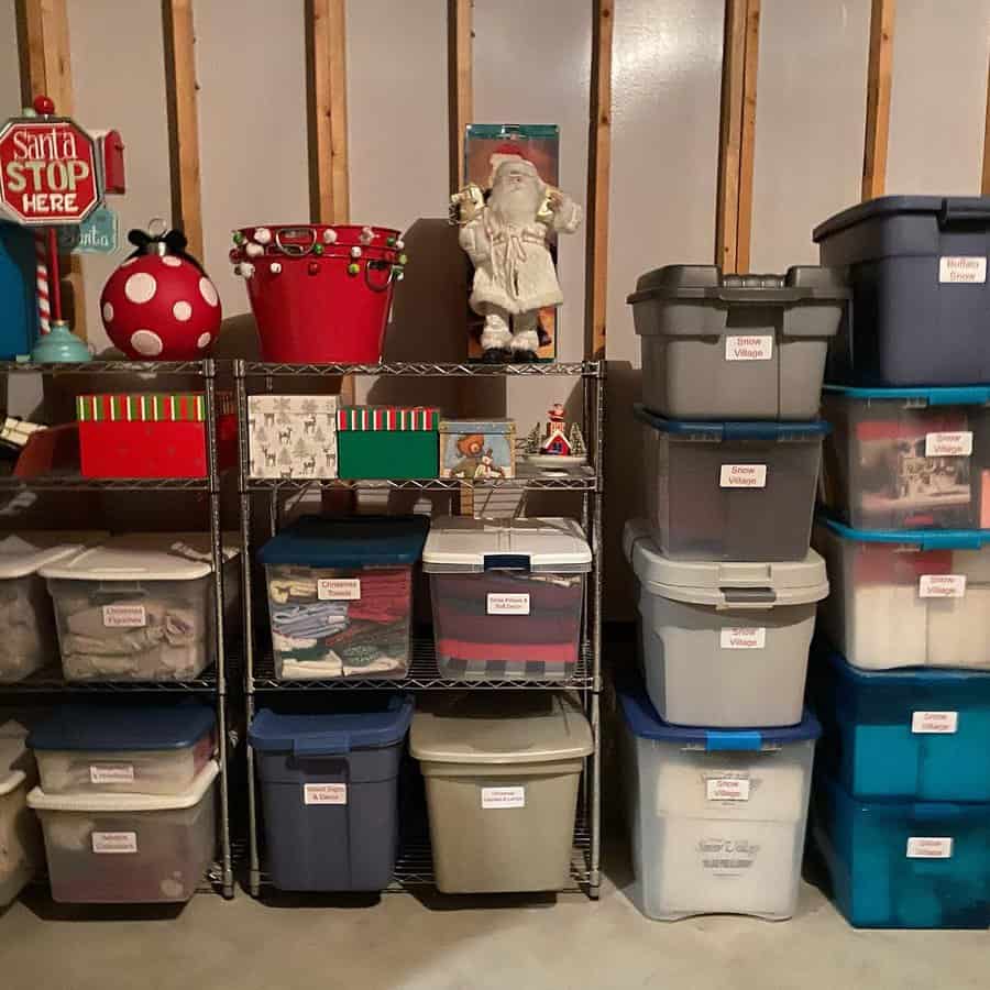 Labeled storage bins neatly stacked on shelves in an attic, organizing Christmas decorations and holiday items for easy access.