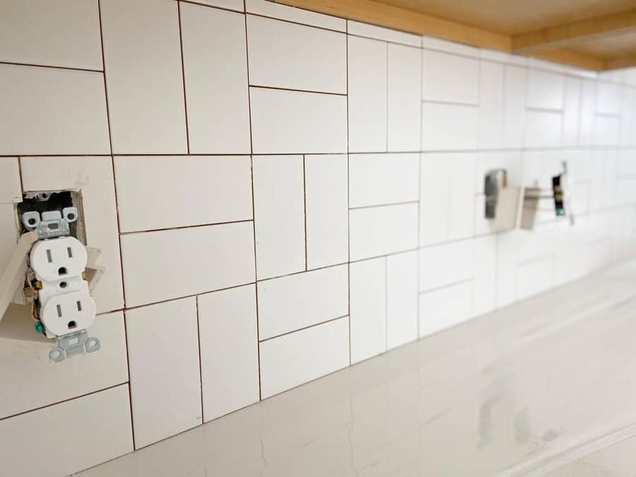 White kitchen with white beveled tiles