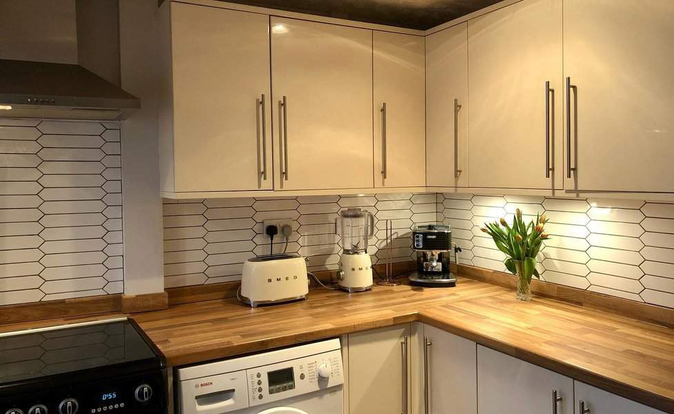 White kitchen with white beveled tiles