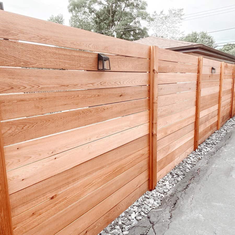 Sleek horizontal wooden fence with outdoor lanterns