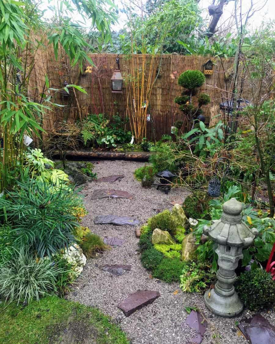 A serene Japanese garden with a stone pathway, bamboo, lantern, and lush green plants surrounded by a bamboo fence