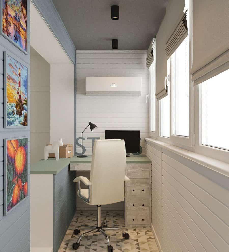 Enclosed balcony transformed into a compact home office with a sleek desk, ergonomic chair, and natural light from large windows