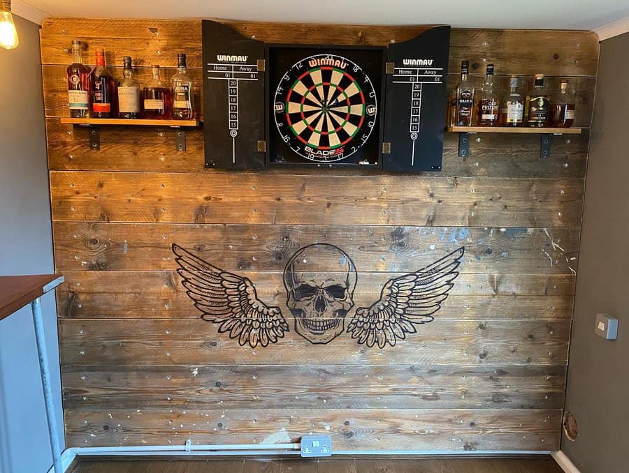 Wooden wall with darts and skull art