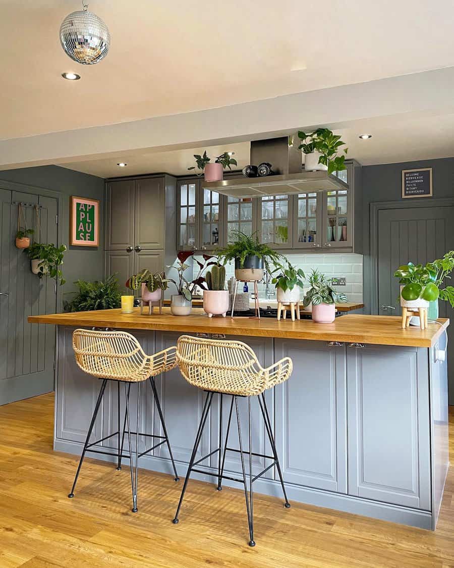 Kitchen island with wicker bar stools and plants