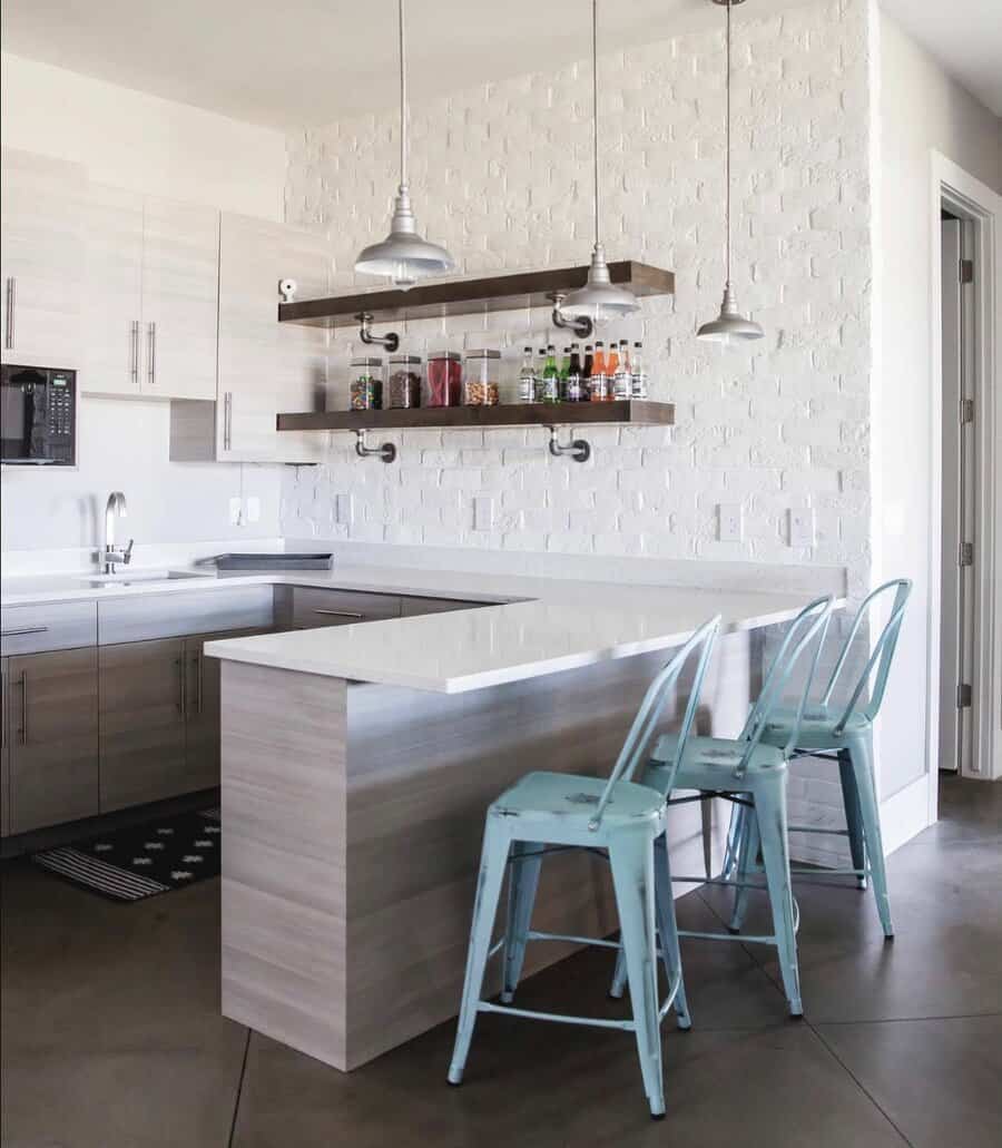 Minimalist kitchen bar with metal stools and pendant light