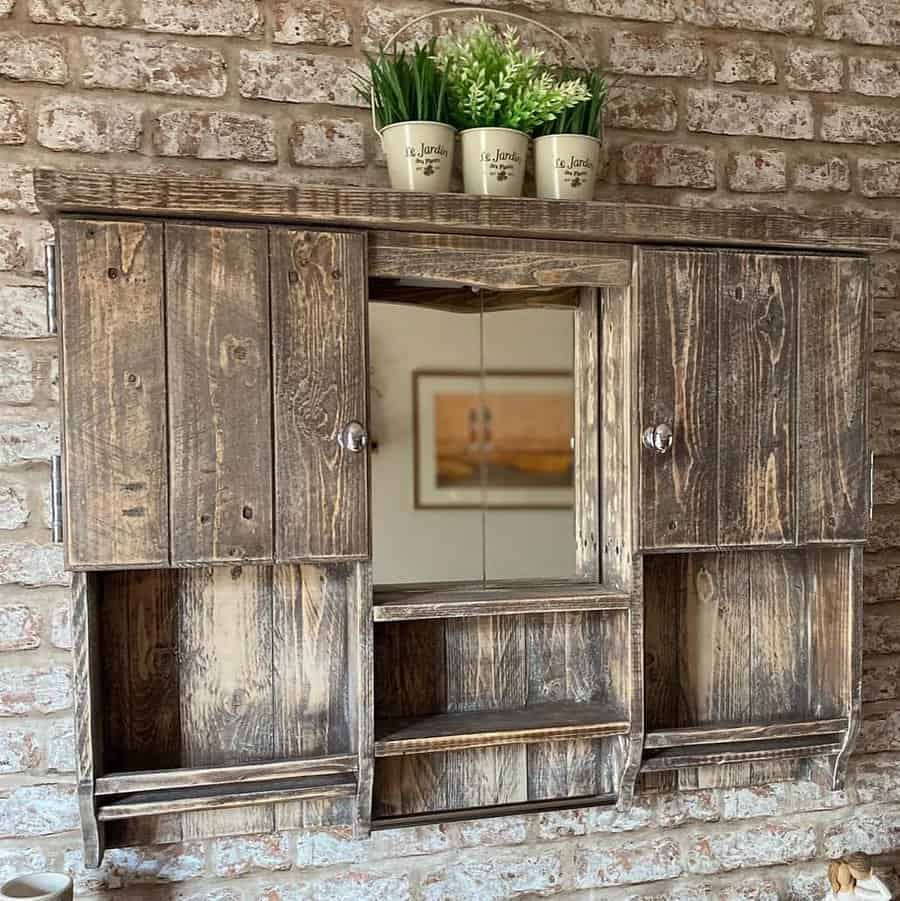 Vintage wooden cabinet on a brick wall with plants