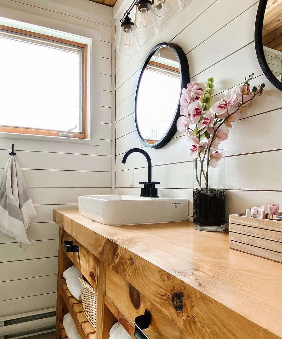 Bathroom With Shiplap Wall With Round Mirror Vanity