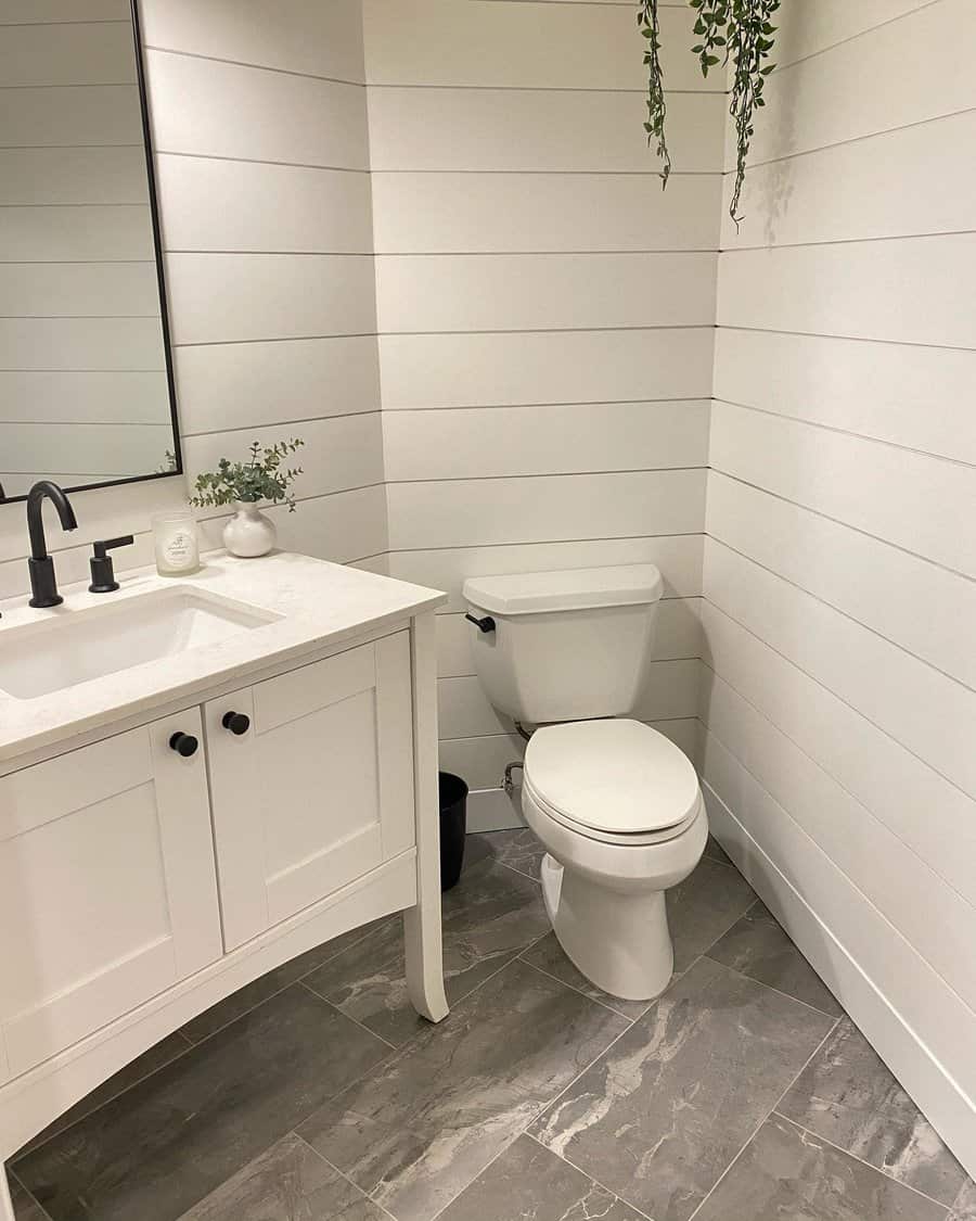 Modern bathroom with shiplap walls and grey floor tiles