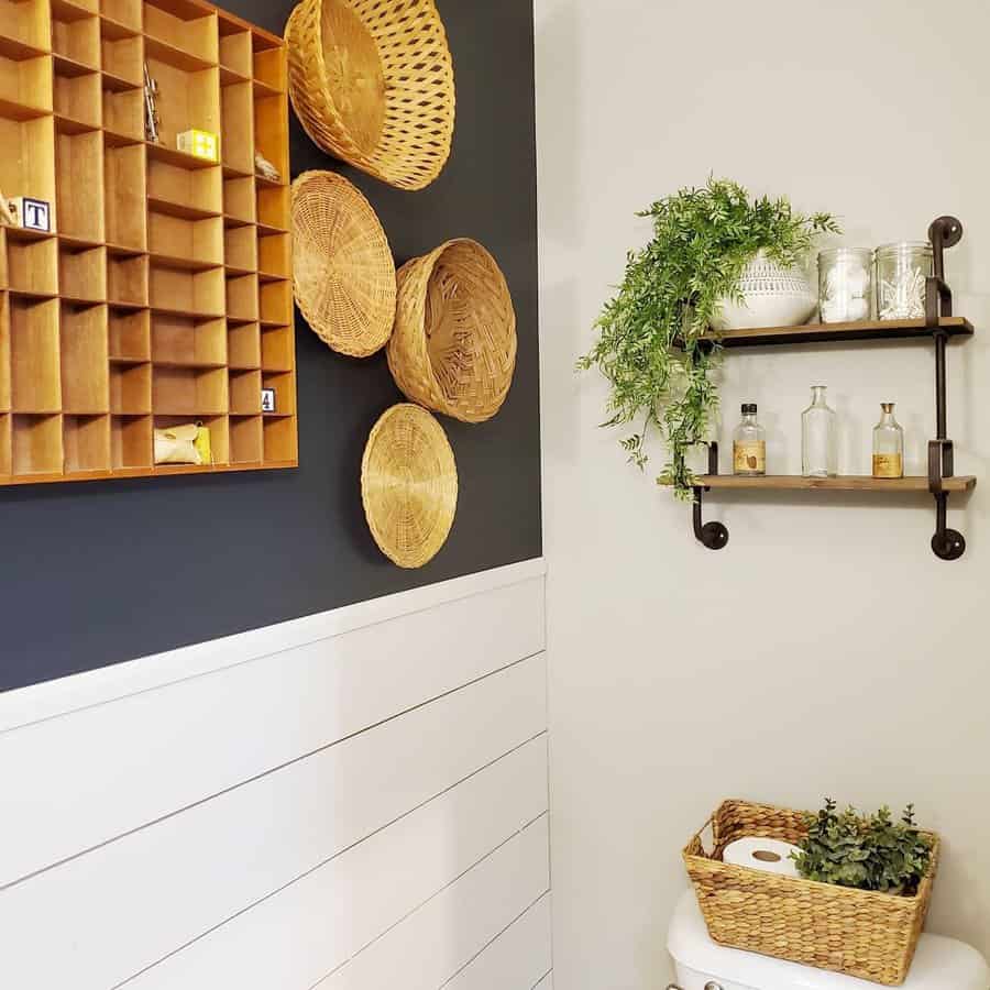 Bathroom decor with wicker baskets, a wooden shelf with toiletries, small plants, and a storage box above a white shiplap wall