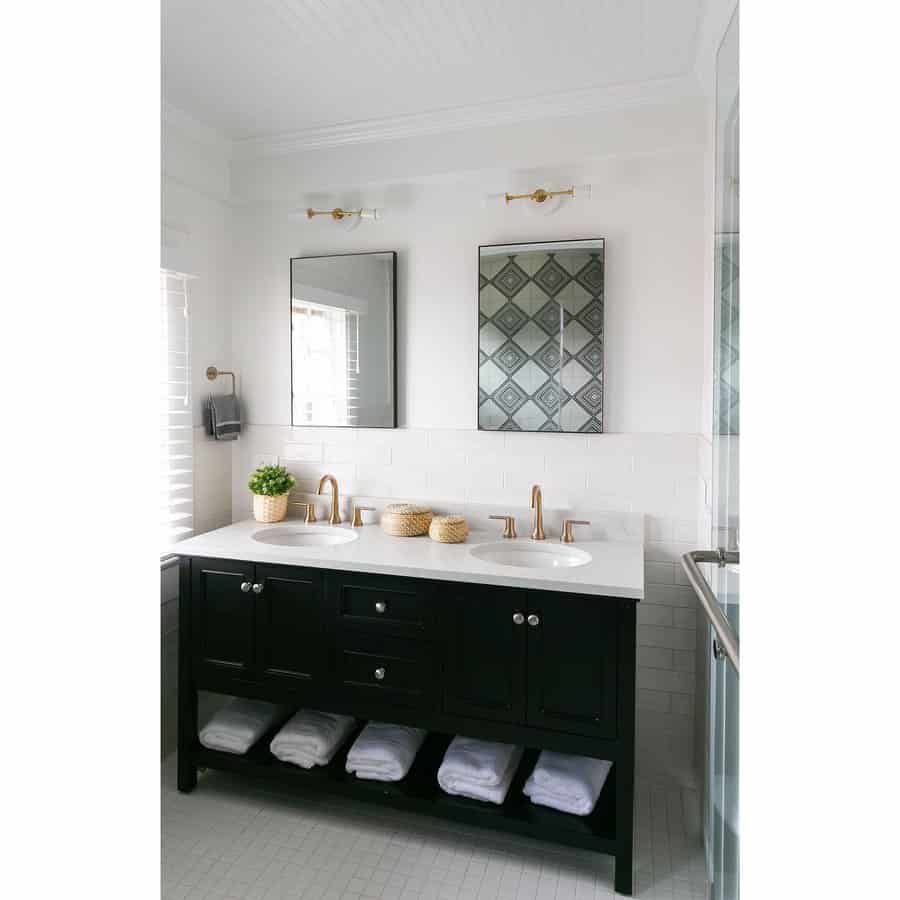 Bright bathroom with a white beadboard ceiling, black vanity, gold fixtures, and a clean, modern aesthetic for a timeless and elegant look.