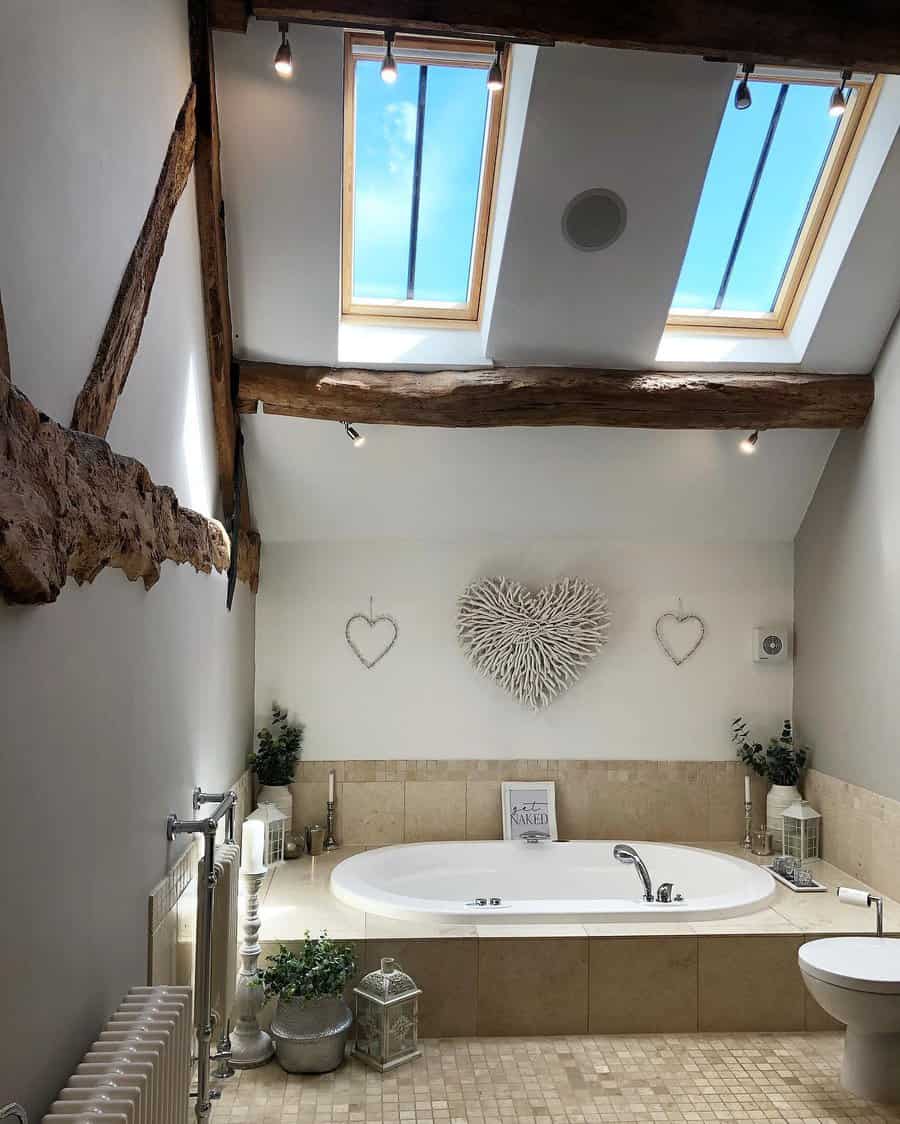 Rustic bathroom with exposed wooden beams, skylights, and soft neutral tones, creating a bright and cozy retreat with natural charm.