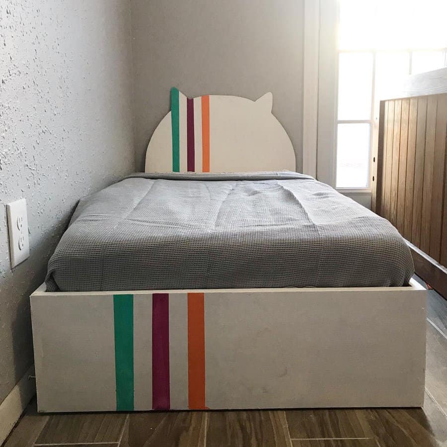 Creative bed with striped cat headboard and drawer
