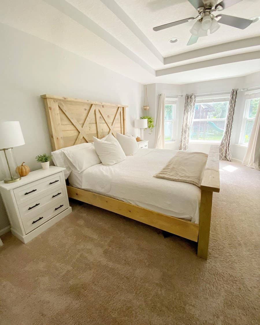 Bright bedroom with wooden bed frame and barn door headboard