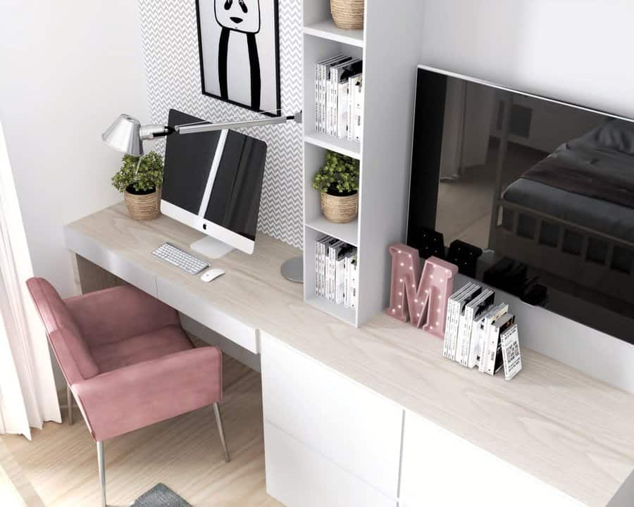 Modern bedroom office with a sleek wood desk, built-in storage, a pink velvet chair, and stylish decor, blending work and rest spaces