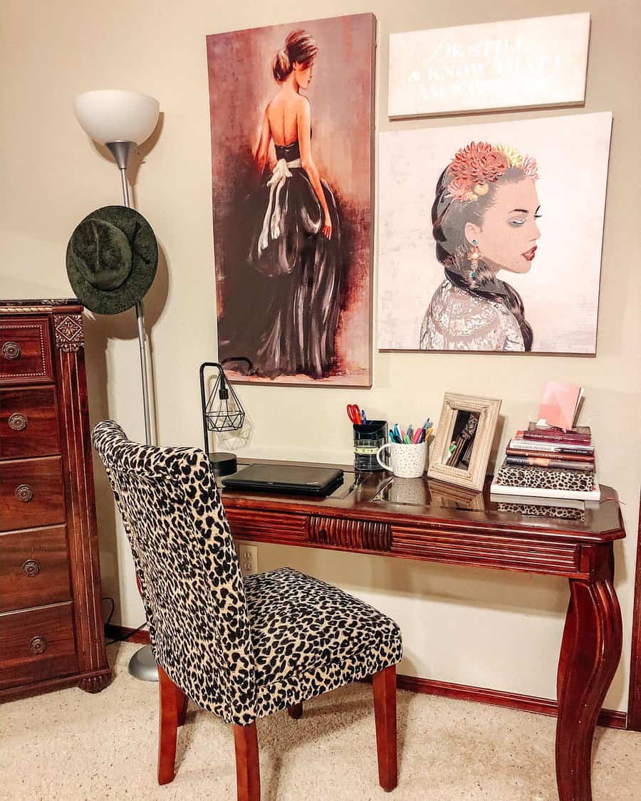 Stylish bedroom office with a vintage wooden desk, leopard-print chair, and elegant wall art, creating a chic and cozy workspace