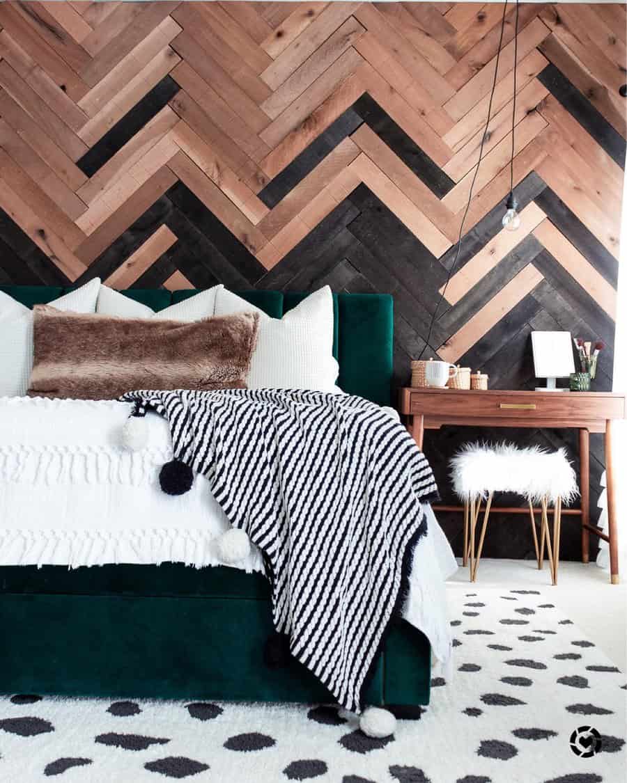 Stylish bedroom with chevron wood wall and plush green bed