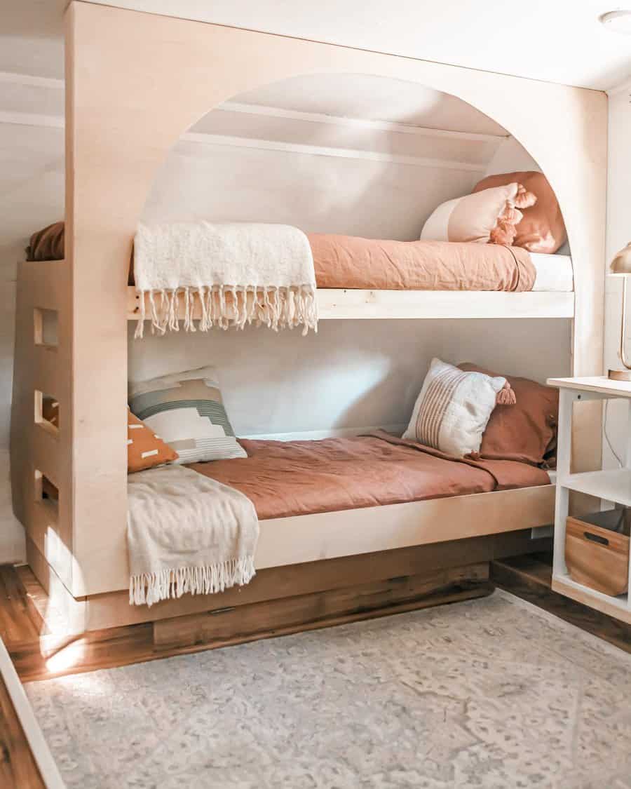 Warm toned RV bunk beds with cozy textiles