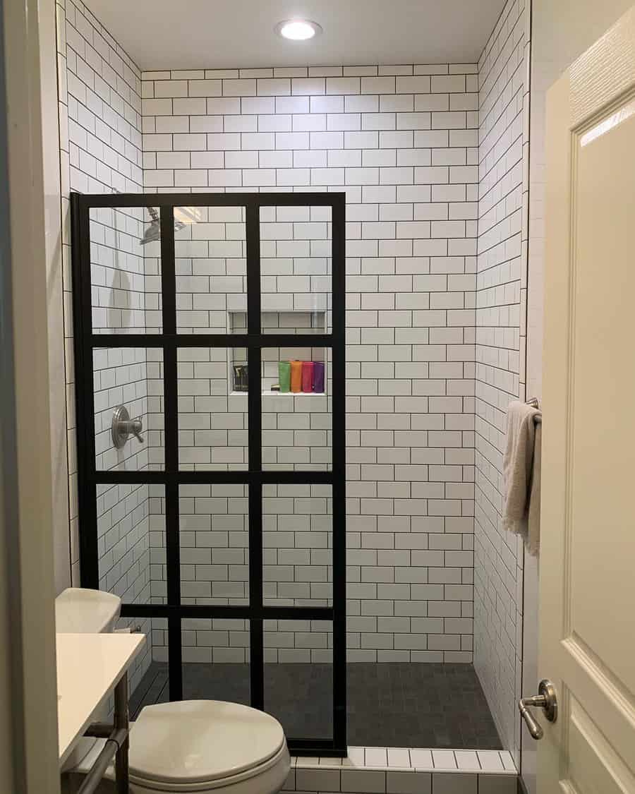walk-in shower with black-framed splash screen