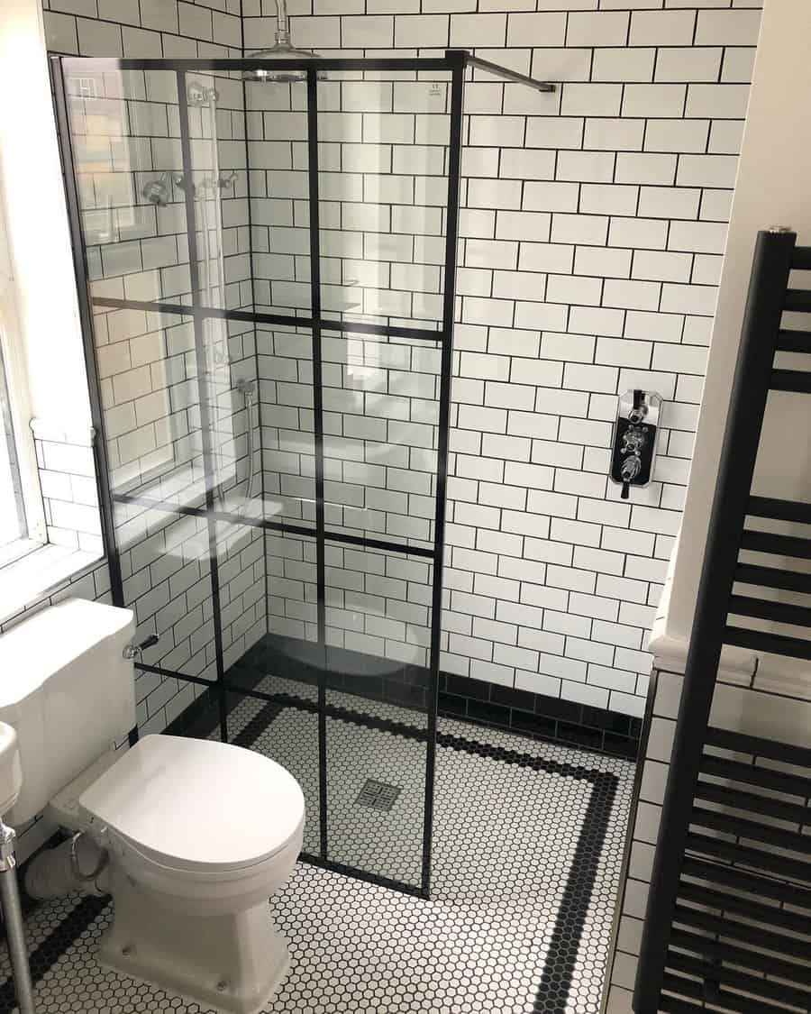 Walk in shower with black and white subway tile