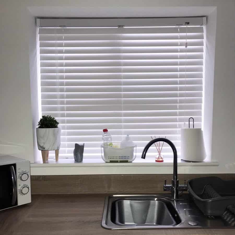 white kitchen with white window blinds