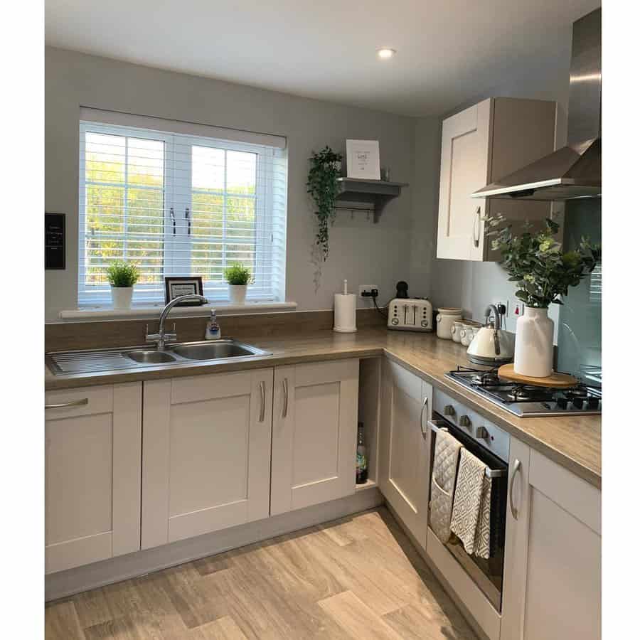 white kitchen with white window blinds