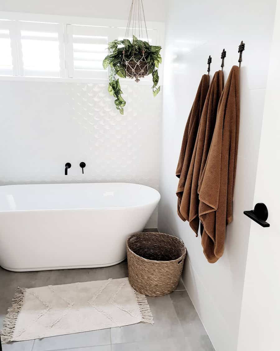 Bohemian style bathroom with hanging plant and freestanding tub